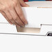 A person using a hand to lift the lid off of a white Banker's Box.
