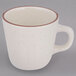 A Tuxton Tall China cup with a brown speckled rim.