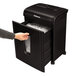 A hand using a Fellowes MicroShred 62MC paper shredder.