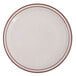 A close-up of a Tuxton white china plate with a brown speckled narrow rim.