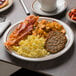 A Tuxton Bahamas brown speckle narrow rim china plate with breakfast food on it.