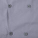 A close up of the buttons on a gray Chef Revival long sleeve chef jacket.