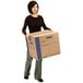 A woman carrying a Banker's Box SmoothMove Prime medium moving box.