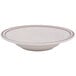 A white soup bowl with a brown speckled rim.