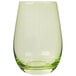 A close up of a Stolzle green stemless wine glass with a clear glass and green liquid.