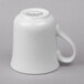 A Libbey Basics bright white tall cup with a handle.