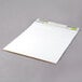 A white paper pad on a gray surface.