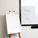 A Universal white recycled self stick easel pad on a stand.