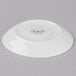 A white Libbey porcelain saucer with a small white circle in the center.
