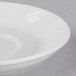 A Libbey bright white porcelain saucer with a rim.