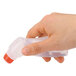 A hand holding a Universal envelope moistener with a red cap.