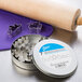 A circular metal tin with a label for Ateco stainless steel leaf cutters, metal cookie cutters, and a rolling pin.