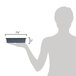 A woman using a Matfer Bourgeat square cake pan on a counter.