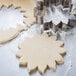 Stainless steel Ateco Dahlia flower cookie cutter on cookie dough.