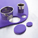 A close-up of a metal Ateco fluted oval cookie cutter.