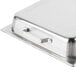 A Vollrath stainless steel hinged dome lid on a metal tray.