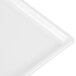 A close-up of a white Tablecraft rectangular cast aluminum cooling platter.