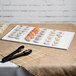 A Tablecraft white cast aluminum rectangular cooling platter on a table with sushi on it.