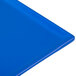 A close-up of a cobalt blue Tablecraft cast aluminum rectangular cooling platter.