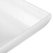 A close up of a white Tablecraft cast aluminum rectangular platter with a flared edge.