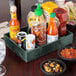 A HS Inc. jalapeno condiment organizer on a table with bowls of salsa and condiments.