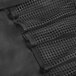 A close up of a black fabric Dexter-Russell cutlery roll with mesh pockets.