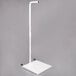 A white rectangular metal stand with a pole and a Cardinal Detecto hanging scale on it.