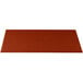 A rectangular copper cast aluminum cooling platter with a red surface and a logo on it.