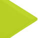 A lime green rectangular cast aluminum cooling platter with a textured surface.