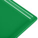 A green cast aluminum rectangular cooling platter with a flat edge.