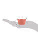 A hand holding a small polyethylene ramekin of paprika.