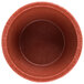 A close-up of a red HS Inc. polyethylene ramekin.