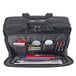 A close up of a black Solo Pro CheckFast briefcase with various items inside.