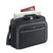 A Solo black laptop bag with a laptop, magazine, and a handle.