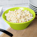 A Tablecraft lime green cast aluminum serving bowl filled with macaroni salad.