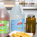 A jug of distilled white vinegar on a counter.