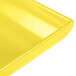 A close-up of a yellow Tablecraft flared rectangular platter.