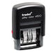 A black Trodat self-inking date stamp with white text.