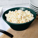 A Tablecraft hunter green cast aluminum bowl with macaroni salad inside.