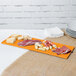 A Tablecraft orange cast aluminum rectangular cooling platter with meat and cheese on it.