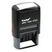 A black Trodat self-inking date stamp with white text and a red button.