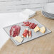 A Tablecraft natural cast aluminum rectangular cooling platter with meat and cheese on it.