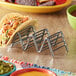 A Clipper Mill stainless steel taco holder with tacos on it.