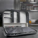 A black Dexter-Russell cutlery case with 27 pockets containing knives.