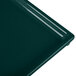 A close-up of a Tablecraft hunter green rectangular cast aluminum cooling platter.