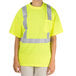 A young man wearing a Cordova lime yellow high visibility safety shirt.