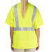 A person wearing a yellow Cordova high visibility safety shirt with reflective stripes.