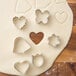 A Wilton 6-piece metal mini cookie cutter set on dough.