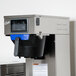 A Curtis commercial iced tea brewer with a black plastic container and a screen.