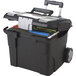 A black Storex rolling file cart with files inside.